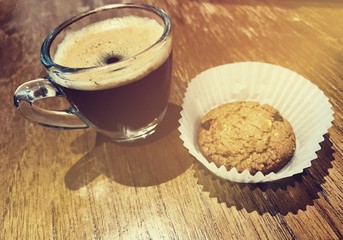 Closeup of chocolate cookies and a cup of coffee. Symbolic image. Concept for a tasty snack. Sweet dessert. Selective focus. Close up.