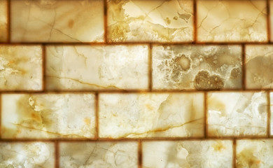 Onyx brick wall background. Texture of honey color onyx material