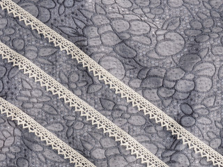 Lace on a background of gray fabric. Concept sewing still life