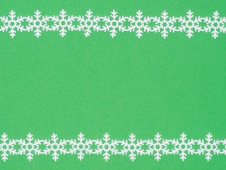 White laces snowflake on green background. Christmas and New year concept
