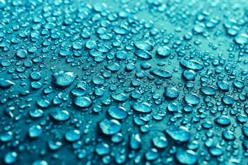 Water drops on the fabric. Rain water droplets on blue fiber wat.