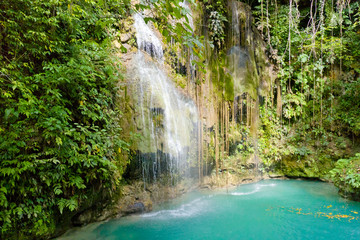 Aerial view of Cambais waterfalls in a mountain gorge in the tropical jungle, Philippines, Cebu. Waterfall in the tropical forest. Clean streams of water and a lake in the jungle.