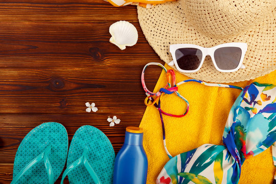 Vacation travel equipment Straw hat, sunglasses And marine objects, shells, on wooden floor - Image