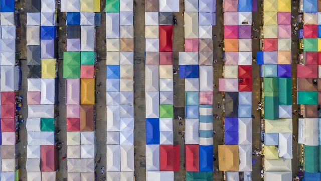 aerial top view train night market ratchada multi color beautiful abstract art time lapse view in bangkok, bangkok market, thailand.