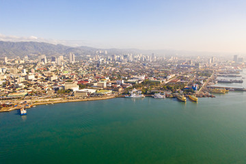 Fototapeta na wymiar Cityscape in the morning. Streets and seaport of the city of Cebu, Philippines, top view. Panorama of the city with houses and business centers.