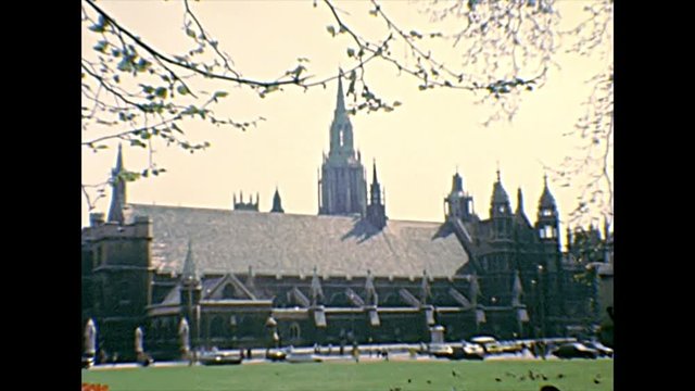Westminster Palace with Big Ben clock tower of London Parliament from Parliament Square Garden. Statues of Jan Smuts and Winston Churchill. Archival restored footage in 1970 in England, United Kingdom