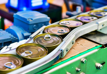 Canned food products on conveyor belt in distribution warehouse.parcels transportation system...