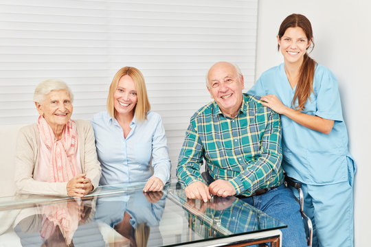 Happy family with seniors couple and nurse