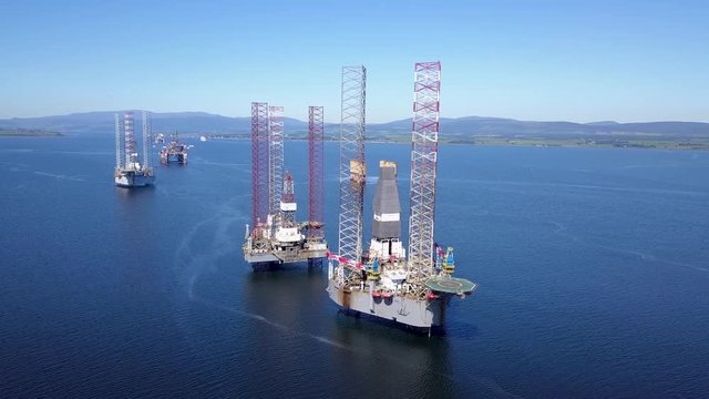 Drone In High Orbit Around Oil Rig Close To Shore