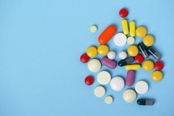 A pile of colorful medicines at blue background