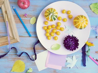 Fototapeta na wymiar Fresh vegetables, fruits and decor on a blue background, top view, season of summer, autumn