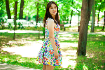 Fototapeta premium Young beautiful woman in dress in the summer park
