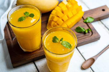 Refreshing and healthy mango smoothie in a glass with mango