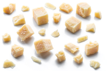 Parmesan cheese cubes and parmesan crumbs isolated on white background.