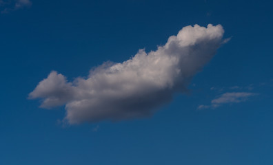 white clouds float across the blue sky