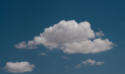 white clouds float across the blue sky