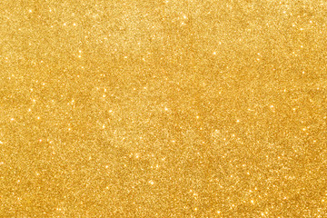 shine and sparkle of golden glitter abstract background	