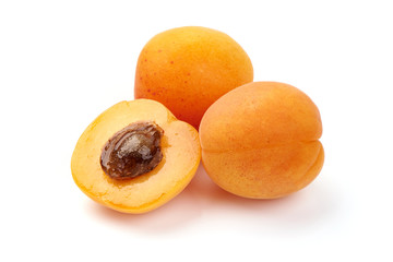 Fresh apricot fruits with juicy half, ripe nectarines, close-up, isolated on white background