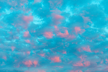 Fototapeta na wymiar clouds in red violet colors with blue sky in sunset