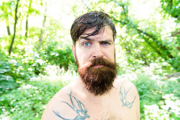Brutal and rugged. Hairy hipster wearing long beard and mustache in brutal style. Bearded man with...