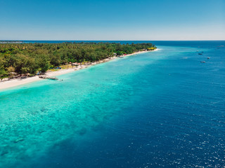 Naklejka na ściany i meble Tropical beach with turquoise ocean in paradise island. Aerial view. Paradise holiday resort