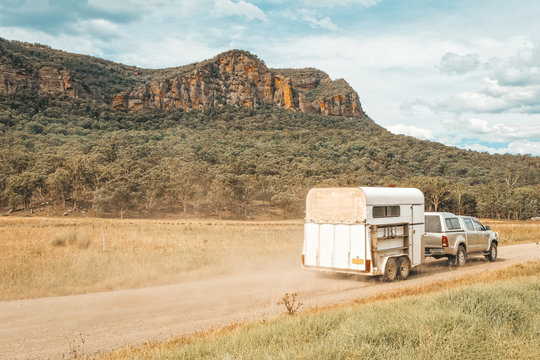 Horse Float Pulled By Four Wheel Drive Along A Dirt Road In Rural Australia