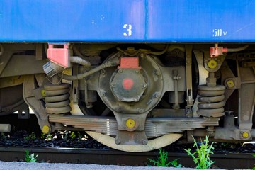 Modern railway pair of wheels with shock absorbers on rails.