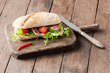 Delicious sandwich on wooden background