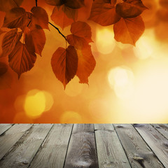 Naklejka na ściany i meble Autumn Background with Red Linden Leaves and Abstract Bokeh Glitter with empty dark wooden board background