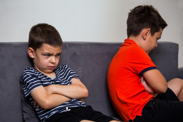 Angry kid offended not talking ignoring brother after fight, jealous kid brother avoiding preschool...