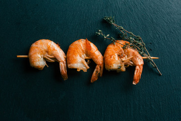 Laconic still life photo of stick with fried prawns