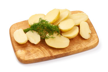 Boiled potato pieces on a cutting board, close-up, isolated on white background
