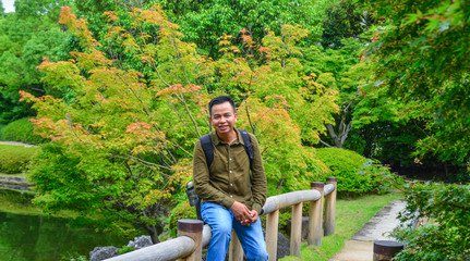 Fototapeta premium A young man enjoying at summer garden