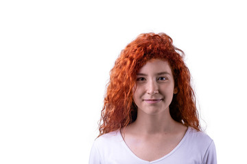 Caucasian red haired girl with green eyes looking into camera