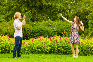 Fototapeta premium Couple blowing bubbles outdoor