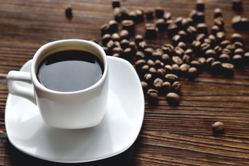 white coffee cup, morning side light coffee beans, natural wooden background