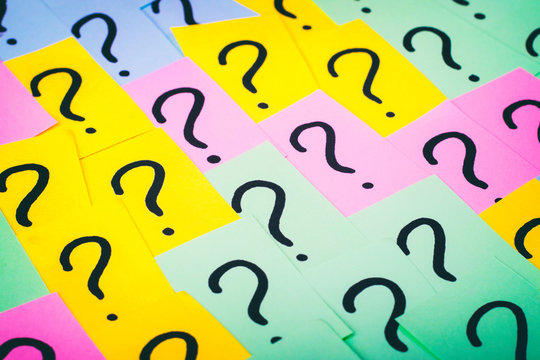 Question marks background. Colorful paper notes with question marks. Concept image. Closeup top view toned
