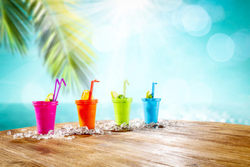 Summer drink on desk and beach landscape 