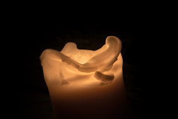 Fototapeta na wymiar Burning candle on a black background - flame photography