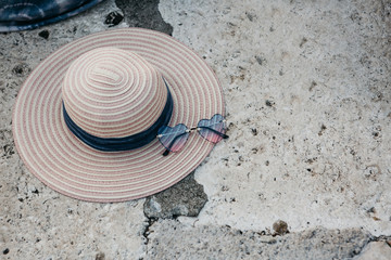 Fototapeta na wymiar Women's hat and sunglasses top view. Summer concept.