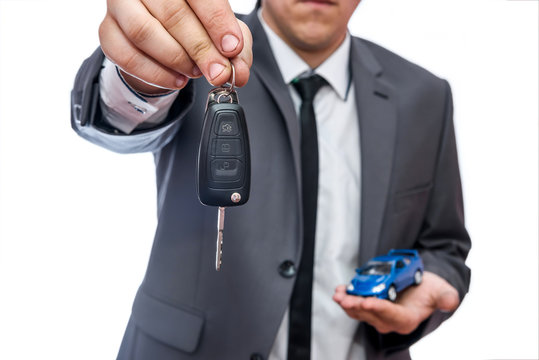 Man Holding Toy Car And Keys Isolated On White