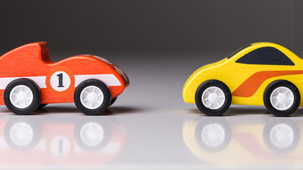 Tiny racing toy cars on a white board