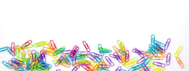 Panorama of colorful paper clips isolated on white background with copy space. Back to school web banner.
