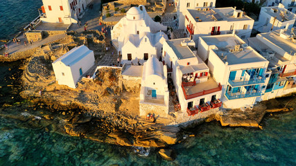 Aerial drone photo of popular landmark chapel of Paraportiani with beautiful emerald colour rocky...