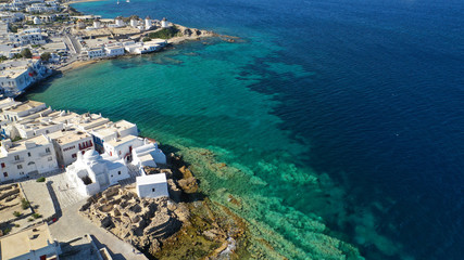 Aerial drone photo of popular landmark chapel of Paraportiani with beautiful emerald colour rocky...