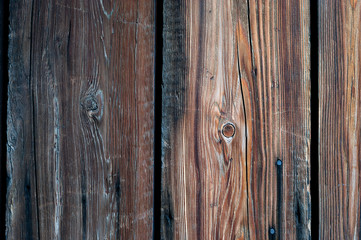 Vertical Weathered Hardwood Boards with Snags, Metal Nail Heads and Gaps.
