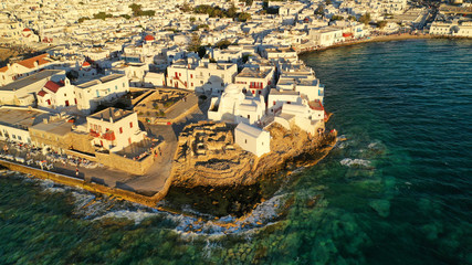 Aerial drone photo of popular landmark chapel of Paraportiani with beautiful emerald colour rocky...