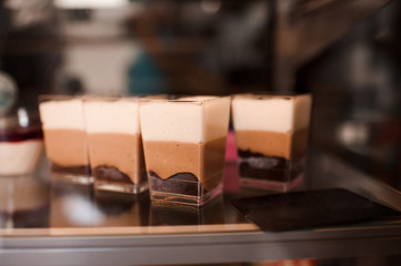 Chocolate cakes in show window closeup.
