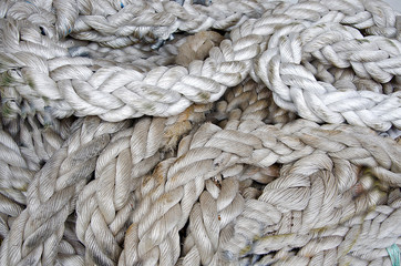 Marine knots and ropes in the tallship. Thick ropes on a wooden sailing ship floor