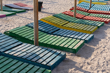 Colorful sunbeds and umbrellas at the beach